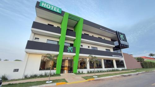 a hotel with a green sign on the side of it at Nature Bonito Hotel in Bonito