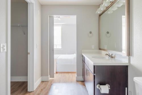 a bathroom with a sink and a mirror at Blueground Mountain View pool nr Shoreline Park SFO-1928 in Castro City