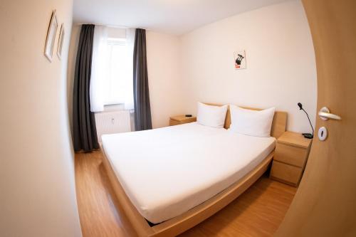 a bedroom with a large white bed with a window at Apartment in Prerow with terrace & close to the beach in Prerow