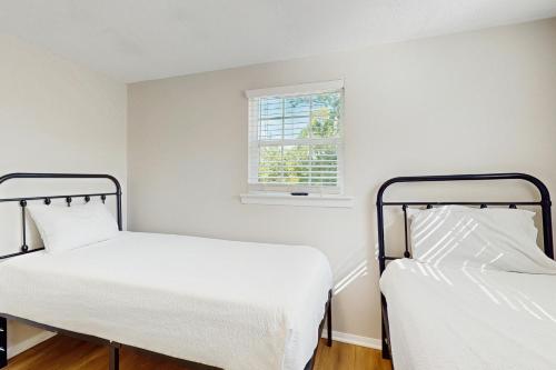 zwei Betten in einem Zimmer mit Fenster in der Unterkunft Baydream Believer in Fort Morgan