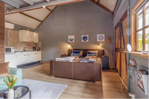 a bedroom with a bed in the middle of a room at Shed 100 in Westerlee