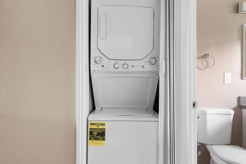 a refrigerator freezer with a mirror on top of it at Blueground Downtown pool nr Civic Center SFO-2069 in Hayward Park