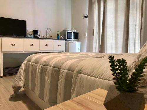a bedroom with a bed and a tv and a couch at LÁZARO Suites in Monterrey