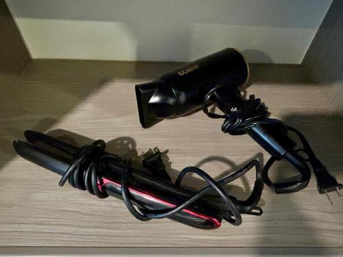 a hair dryer sitting on top of a wooden table at LÁZARO Suites in Monterrey