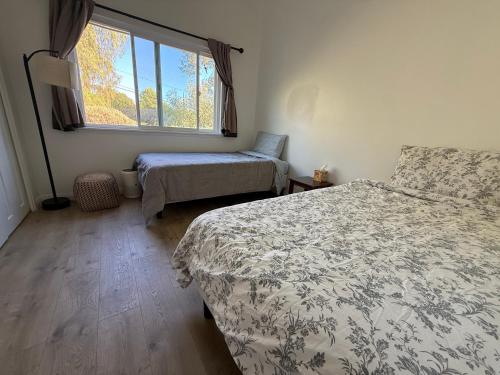 a bedroom with two beds and a window at Paradise at Tree Ranch Grove in Ojai