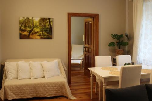 a living room with a couch and a table at Zacisze by the Park in Szczawno-Zdrój