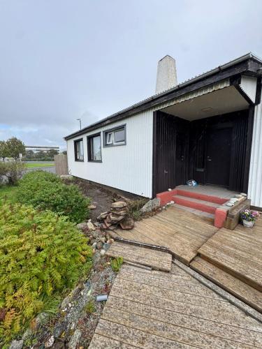 a house with a deck and a building at Home in höfn renovations finished by 16th october in Höfn
