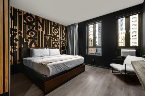 a bedroom with a bed with a black wall at Audemar Boutique Hotel and Apartment Homes in Los Angeles