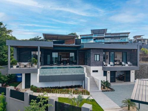 a rendering of a house with a swimming pool at Beach Mode Luxury 3-Story House in Tamarindo in Tamarindo