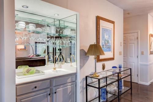 a kitchen with a sink and a glass cabinet at Chetola: Robin 1 in Blowing Rock