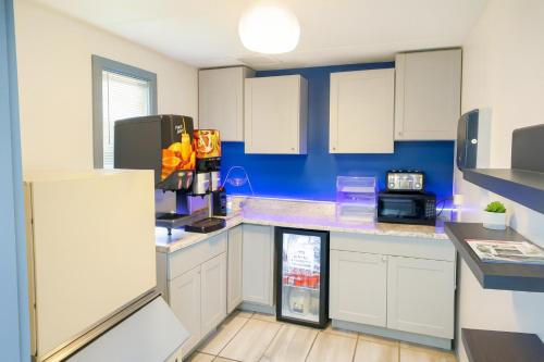 een keuken met witte kasten en een koelkast bij Executive Inn Owatonna Hwy 35 in Owatonna