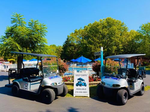 two golf carts are parked in a park at Put-in-Bay Island Club #4 in Put-in-Bay