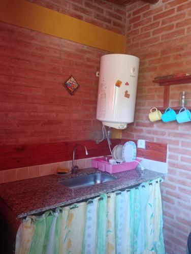 a kitchen counter with a sink and a mixer at Casa Sol Y Rio in Mina Clavero