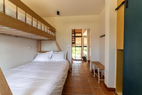 a bedroom with two beds and a staircase at Calipo in Vila Viçosa