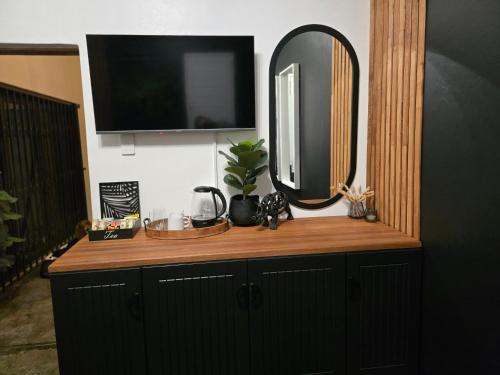 a mirror sitting on top of a wooden dresser at The Blue Shutter Guest House in Haenertsburg