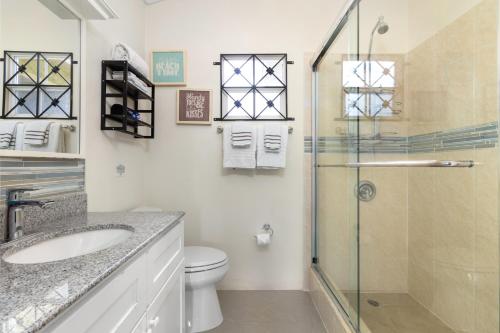 a bathroom with a shower and a sink and a toilet at Three Bedroom Villas in Drax Hall - Pool Gym - 24hr Security - Beach Closely in Saint Annʼs Bay