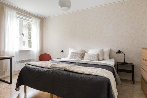 a bedroom with a large bed with white pillows at Relax in peaceful and sunny Marmaverken apartment 