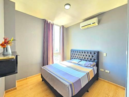 ein Schlafzimmer mit einem Bett und einem Fenster in der Unterkunft Departamento de dos dormitorios en el Corazón de Santa Cruz in Santa Cruz de la Sierra