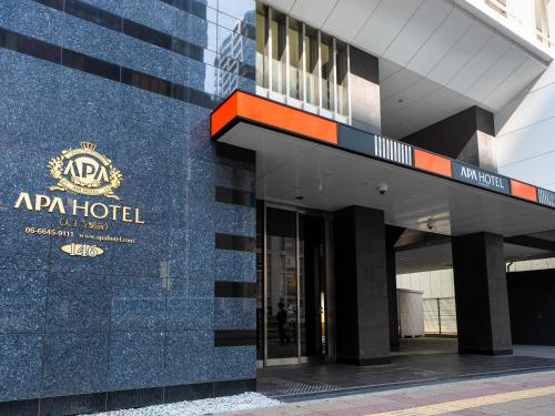 a building with a hotel sign on the side of it at APA Hotel Tennoji Ekimae in Osaka