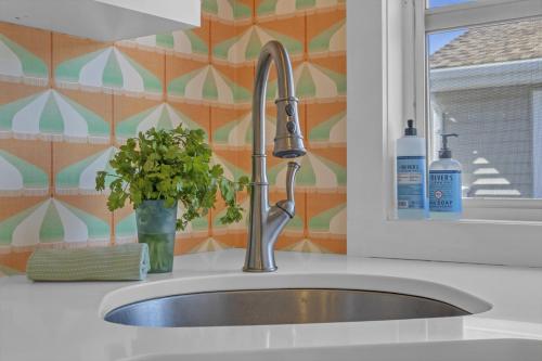 a kitchen sink with a faucet next to a window at Hot Tub 3BR Lavallette Girls Trip at the Beach in Monterey Beach