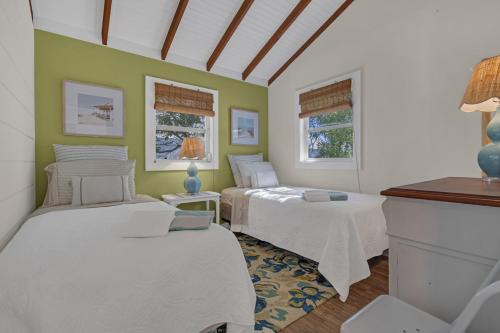 a bedroom with two beds and two windows at Hot Tub 3BR Lavallette Girls Trip at the Beach in Monterey Beach