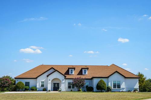 a large white house with a brown roof at Luxury Event and Stay in Celina, Texas in Gunter