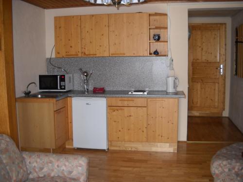 a kitchen with a white refrigerator and a microwave at Ferienwohnungen Pein in Vordernberg