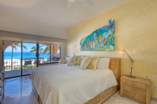a bedroom with a bed and a view of the ocean at Beachfront Condo at Casa del Mar in El Bedito