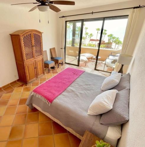 a bedroom with a large bed and a balcony at Oceanview Penthouse Casa Del Mar in San José del Cabo