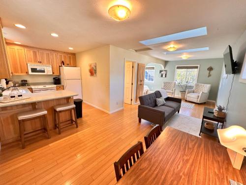 a kitchen and living room with a couch and a table at Medford Home And 2 Condos With Pool in Medford