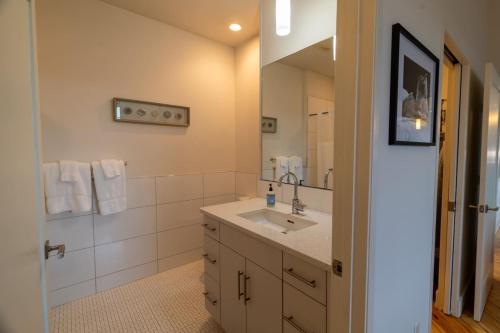 a bathroom with a sink and a mirror at Habour Haven minutes from downtown Mystic in Mystic