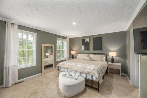a bedroom with a large bed and a mirror at Private Retreat by the Ecusta Trail and Downtown in Horse Shoe