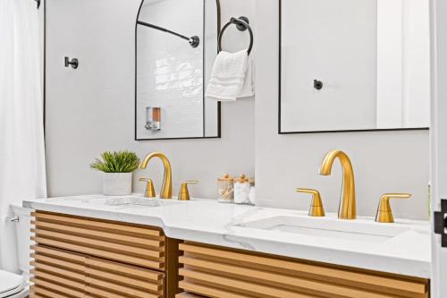 a bathroom with a sink and two faucets at Completely Renovated Home in St. Charles, Missouri in Harvester