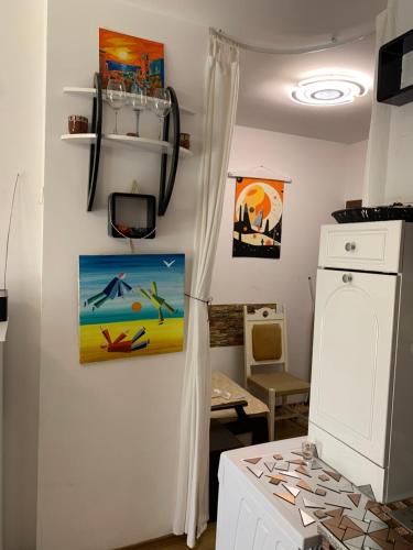 a room with a kitchen with a refrigerator and a washing machine at Sunny view South studio Мир Авангарда in Sunny Beach