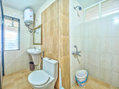 a bathroom with a toilet and a sink at Stunning 4bhk Pool View Apartment 2bhkX2 in Vagator