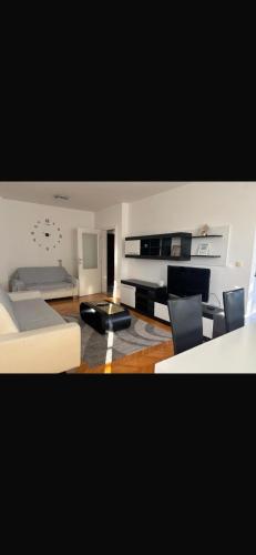 a living room with a bed and a couch at Apartman Centar 1 in Bijeljina