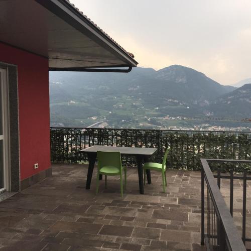 a table and chairs on a patio with a view at Casa Lampone in Trento
