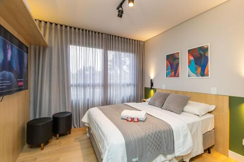 Postel nebo postele na pokoji v ubytování Studio Super Completo em Região Tranquila -EIX0202