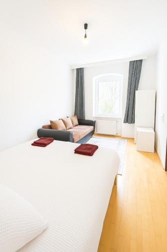 a living room with two beds and a couch at Beenie MG in Linz
