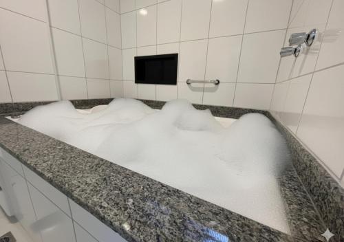 a bath tub filled with snow in a bathroom at Hotel Itamarati Centro-República in Sao Paulo