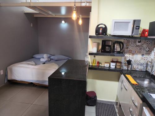 a small kitchen with a small bed in a room at Pousada Confort in Sao Paulo