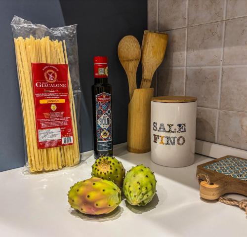 two artichokes sitting on a kitchen counter with some ingredients at Il fico d'india in Marsala