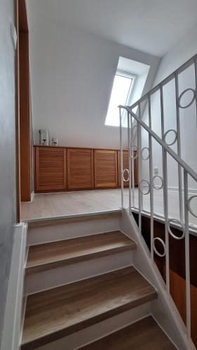 a staircase in a building with a window at Pension mit Meer in Cuxhaven