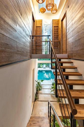 a home with a swimming pool and stairs at Green House 2 in Nicoya