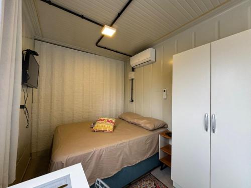 TijucasAconchego Urbano em Tijucas n 06的一间带一张床和一个衣柜的小卧室