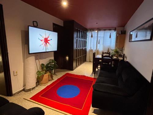 a living room with a couch and a flat screen tv at Departamento en el centro de Oaxaca in Oaxaca City