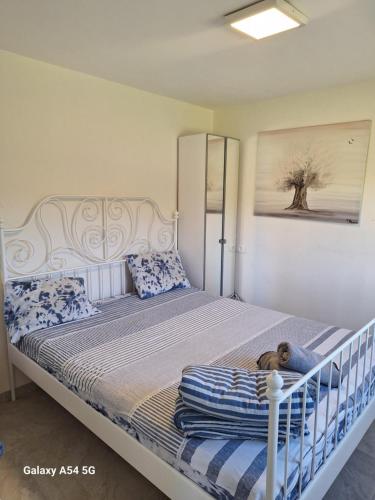 a bedroom with a bed with a dog laying on it at Charming beach 2 room flat in Haifa