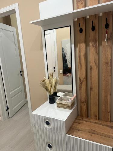 a dressing table with a mirror in a room at Евро двушка in Astana