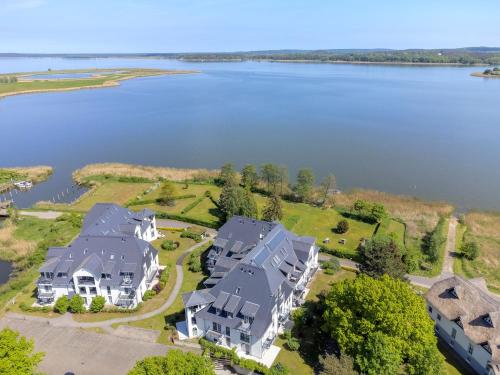 an aerial view of a large house next to a lake at Residenz am Balmer See - BS 09 mit Wellnessbereich in Balm