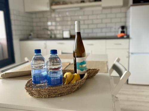 a bottle of wine and two bottles of water on a counter at Farito Sunset in Gáldar